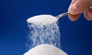 Pouring A Teaspoon Of Sugar